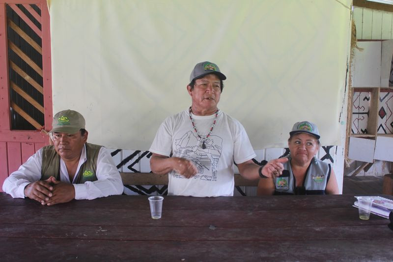Ilson Lopez (center) says sustainable logging provides reliable income while conserving forest.